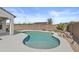Inviting backyard pool surrounded by desert landscaping and a privacy fence at 19203 W Jackson St, Buckeye, AZ 85326