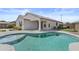 View of the beautiful backyard pool, covered patio, and desert landscaping at 19203 W Jackson St, Buckeye, AZ 85326
