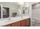 Bathroom with a double sink vanity, bright lighting and an adjacent shower/tub at 2042 W Mark Ln, Phoenix, AZ 85085