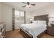 Cozy bedroom with a ceiling fan and plantation shutters for adjustable light at 2042 W Mark Ln, Phoenix, AZ 85085