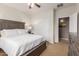 Bedroom featuring a large bed, ceiling fan and ample closet space at 2042 W Mark Ln, Phoenix, AZ 85085