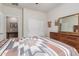 Bedroom featuring a dresser and closet space, seamlessly flowing into an adjacent room at 2042 W Mark Ln, Phoenix, AZ 85085