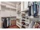 Walk-in closet with built-in shelving and racks for organized storage of clothes and shoes at 2042 W Mark Ln, Phoenix, AZ 85085