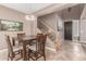 Dining room adjacent to a staircase, showcasing a cozy and inviting living space at 2042 W Mark Ln, Phoenix, AZ 85085