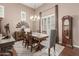 Elegant dining room with a wooden table, upholstered chairs, and a rustic floor rug at 2042 W Mark Ln, Phoenix, AZ 85085