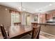 Open dining room featuring a modern chandelier and easy access to the kitchen and an outdoor patio at 2042 W Mark Ln, Phoenix, AZ 85085