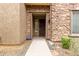 Inviting stone entryway with an ADT security system at 2042 W Mark Ln, Phoenix, AZ 85085