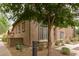 Charming exterior with desert landscaping, stone accents, and mature shade trees at 2042 W Mark Ln, Phoenix, AZ 85085