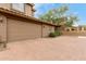 Attached two-car garage with a brick paver driveway and desert landscaping at 2042 W Mark Ln, Phoenix, AZ 85085