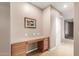 Hallway with a custom wooden built-in desk and drawers for added storage at 2042 W Mark Ln, Phoenix, AZ 85085