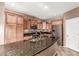 Granite island in kitchen with stainless steel appliances and custom cabinets at 2042 W Mark Ln, Phoenix, AZ 85085