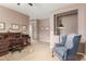 Inviting living room featuring a wooden desk, chair, and a comfortable armchair at 2042 W Mark Ln, Phoenix, AZ 85085