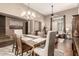Bright, open-concept living room with hardwood floors, a dining area, and neutral decor at 2042 W Mark Ln, Phoenix, AZ 85085
