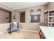 Home office featuring ample desk space, bookshelves, and comfortable seating, suitable for work or study at 2042 W Mark Ln, Phoenix, AZ 85085