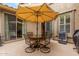 Outdoor patio with seating under a large umbrella, with both covered and uncovered sections at 2042 W Mark Ln, Phoenix, AZ 85085