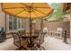 Outdoor patio with seating under a large umbrella, great for entertaining at 2042 W Mark Ln, Phoenix, AZ 85085