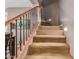 Carpeted staircase with decorative wrought iron railing and recessed lighting for added elegance at 2042 W Mark Ln, Phoenix, AZ 85085