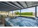 View of backyard hot tub and outdoor seating area under a covered patio at 20822 N 34Th Dr, Phoenix, AZ 85027