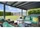 Covered patio with wicker furniture, perfect for outdoor entertaining overlooking the lawn and fence at 20822 N 34Th Dr, Phoenix, AZ 85027