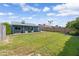 Large backyard with lush green grass, covered patio, and well-maintained landscaping at 20822 N 34Th Dr, Phoenix, AZ 85027
