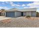 A cozy home featuring a two-car garage, desert landscaping and convenient curb appeal at 20822 N 34Th Dr, Phoenix, AZ 85027