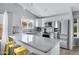 Bright kitchen features updated appliances, white cabinetry, quartz counters, and a mosaic backsplash at 20822 N 34Th Dr, Phoenix, AZ 85027