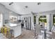 Modern kitchen with white cabinets, stainless steel appliances, and a breakfast bar with seating at 20822 N 34Th Dr, Phoenix, AZ 85027