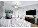 Bright main bedroom with chandelier lighting, stylish decor, and view into ensuite bathroom at 20822 N 34Th Dr, Phoenix, AZ 85027