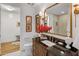Well-lit bathroom with granite counters, modern fixtures, and decorative accents and a large mirror at 2211 E Camelback Rd # 902, Phoenix, AZ 85016