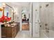 Well-lit bathroom featuring a tile shower and a granite sink countertop, providing a functional and stylish space at 2211 E Camelback Rd # 902, Phoenix, AZ 85016