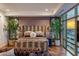 This is a bedroom with plants, mirrored decorations, and an upholstered headboard bed at 2211 E Camelback Rd # 902, Phoenix, AZ 85016