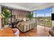 Bedroom with views, wooden floors, and a decorative upholstered headboard at 2211 E Camelback Rd # 902, Phoenix, AZ 85016