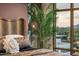 Bright bedroom featuring a large window, decorative pillows, and an elegant hanging light fixture at 2211 E Camelback Rd # 902, Phoenix, AZ 85016