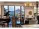 Bright dining room with elegant lighting fixture and mountain views at 2211 E Camelback Rd # 902, Phoenix, AZ 85016