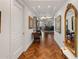 Long hallway features artwork, mirrors, and hardwood flooring at 2211 E Camelback Rd # 902, Phoenix, AZ 85016