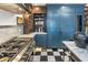 Chef's kitchen featuring a stainless steel range, marble countertops and blue cabinets at 2211 E Camelback Rd # 902, Phoenix, AZ 85016