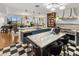Open kitchen with island seating, stainless appliances, and sleek black and white flooring at 2211 E Camelback Rd # 902, Phoenix, AZ 85016