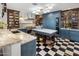 This gourmet kitchen features an island, black and white flooring, and custom cabinetry at 2211 E Camelback Rd # 902, Phoenix, AZ 85016