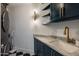 Modern laundry room with sleek washer and dryer, marble countertops, and stylish gold fixtures at 2211 E Camelback Rd # 902, Phoenix, AZ 85016