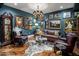 Elegant living room features hardwood floors, stylish decor, and a comfortable leather sofa with ornate art at 2211 E Camelback Rd # 902, Phoenix, AZ 85016