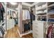 Spacious walk-in closet with custom shelving, drawers, and ample hanging space for organized storage at 2211 E Camelback Rd # 902, Phoenix, AZ 85016