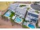 This aerial view showcases multiple homes, all complete with unique backyard pool and patio designs at 22771 N 98Th Dr, Peoria, AZ 85383
