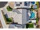 An aerial view showcases the home's roof, solar panels, driveway, and backyard pool with patio at 22771 N 98Th Dr, Peoria, AZ 85383