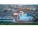 Aerial view of the community pool and recreation area, with a large pool, tennis courts, and green spaces at 22771 N 98Th Dr, Peoria, AZ 85383