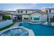 Beautiful backyard oasis featuring a pool, spa, outdoor kitchen, lounge chairs and lush landscaping at 22771 N 98Th Dr, Peoria, AZ 85383