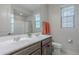 Bathroom featuring double sinks, a large mirror, and a shower-tub combination at 22771 N 98Th Dr, Peoria, AZ 85383