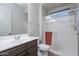 Bright bathroom featuring a glass-enclosed shower, modern vanity, and sleek fixtures at 22771 N 98Th Dr, Peoria, AZ 85383