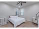 Inviting bedroom featuring a comfortable bed, large windows, and a vanity desk at 22771 N 98Th Dr, Peoria, AZ 85383