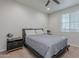 Comfortable bedroom featuring a queen-sized bed with bedside tables and a large window at 22771 N 98Th Dr, Peoria, AZ 85383