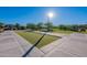 Well-maintained bocce ball court at The Meadows, featuring artificial turf, concrete borders and a sunny location at 22771 N 98Th Dr, Peoria, AZ 85383